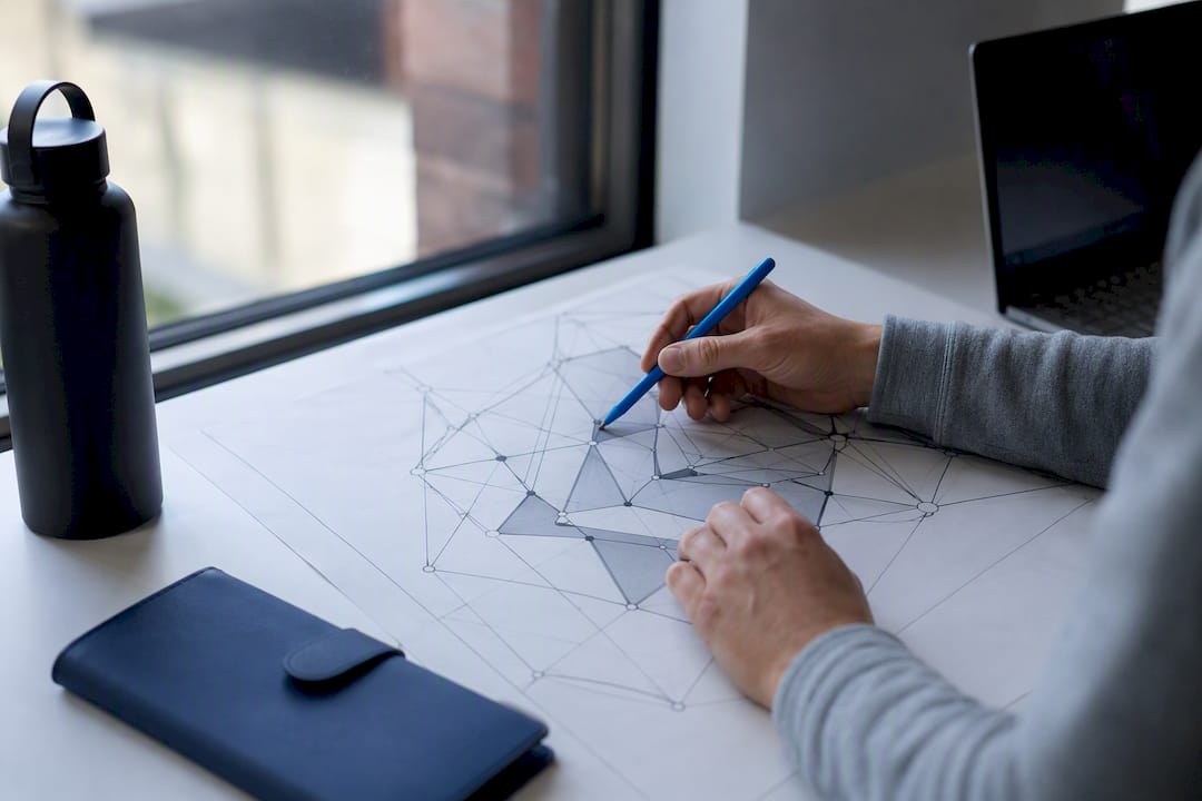Hands pointing at site architecture map on desk