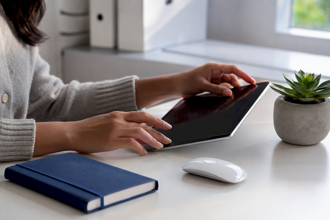 Hands organizing digital brand hub workspace